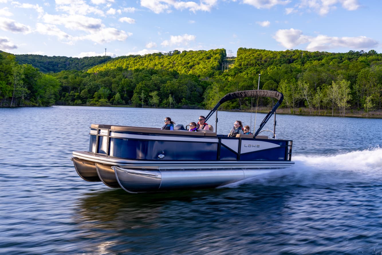 Lowe LF-232 pontoon underway on the lake with passengers aboard